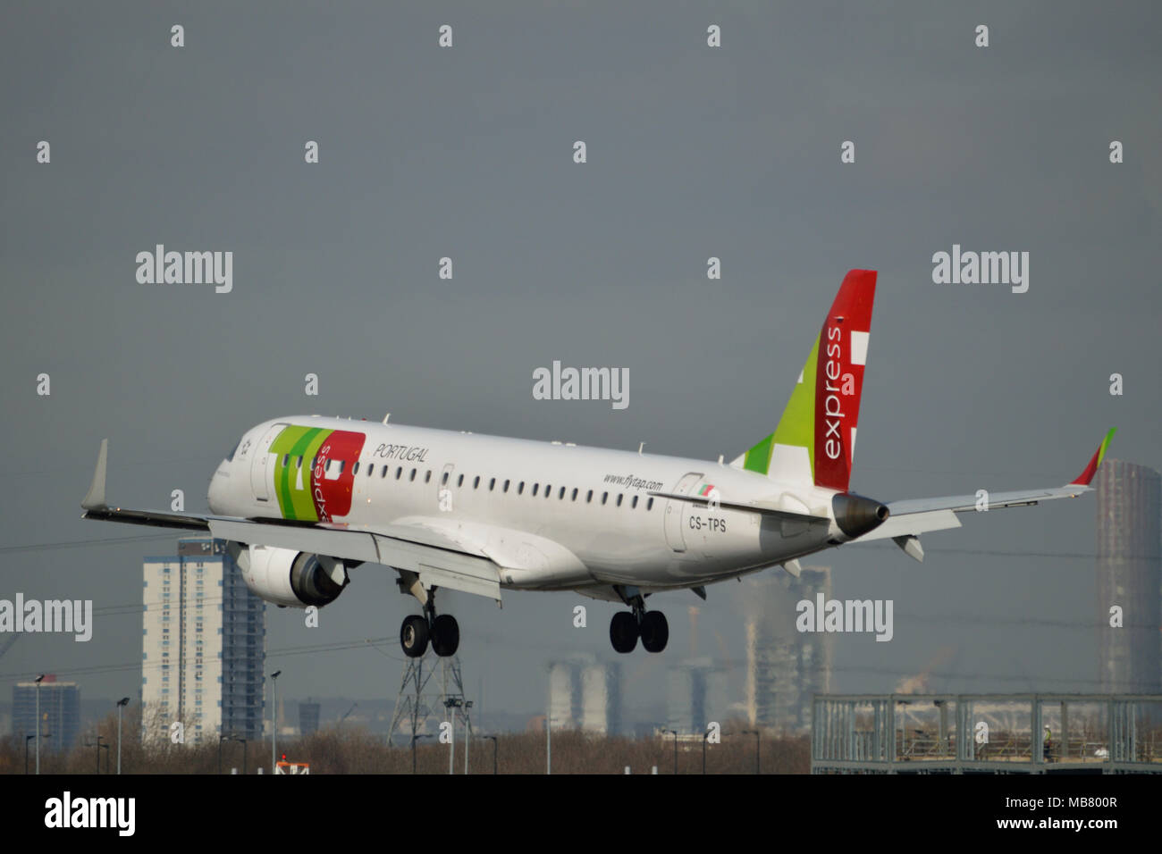 TAP Express Embraer 190 aircraft on approach to London City Airport Stock Photo