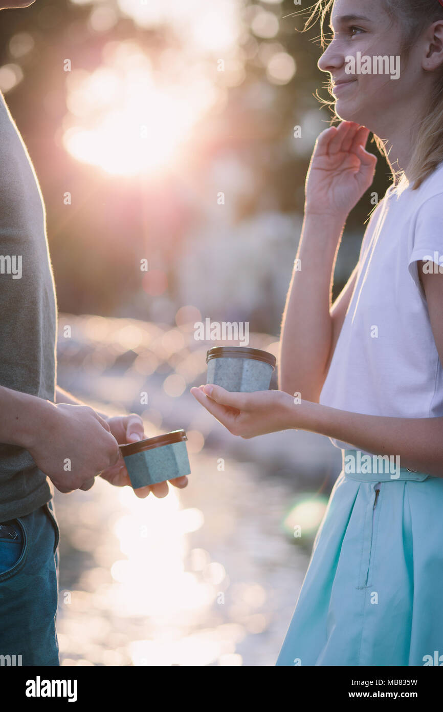 Young teenage girl and boy spending time together in the city centre enjoy eating ice cream on a summer day. Spending quality time on sunny afternoon Stock Photo