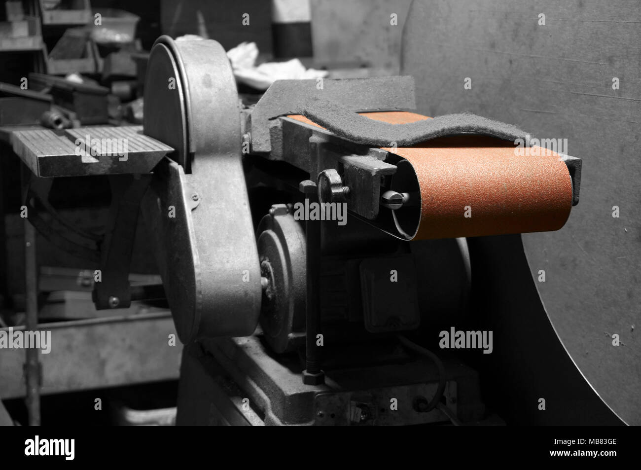 Industrial belt sander in a factory with selective color Stock
