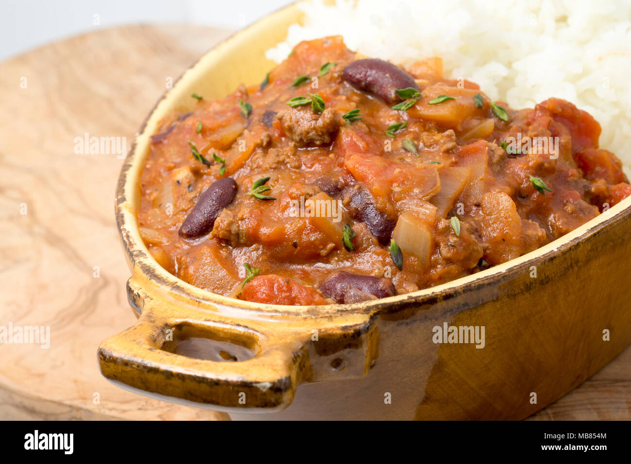 Chili con carne made from minced venison from a roe deer, Capreolus capreolus, kidney beans, tomatoes, onions, spices and sprinkled with fresh thyme.  Stock Photo