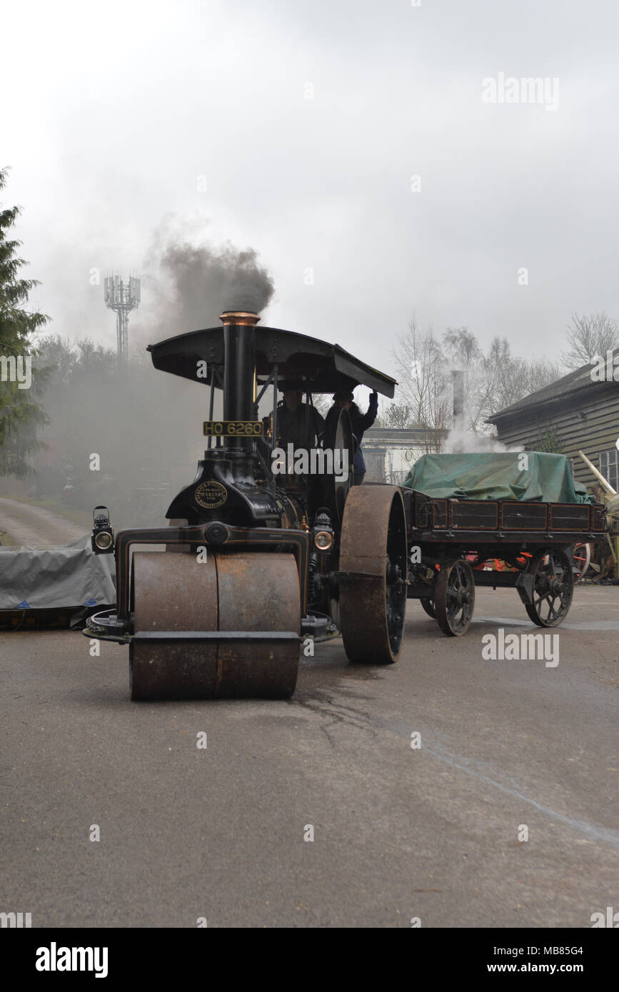 Steam rollers and traction engines in a vintage road works scene, steam