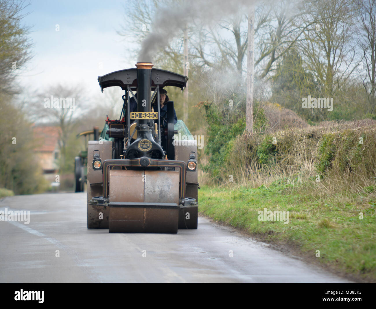 Steam rollers and traction engines in a vintage road works scene, steam