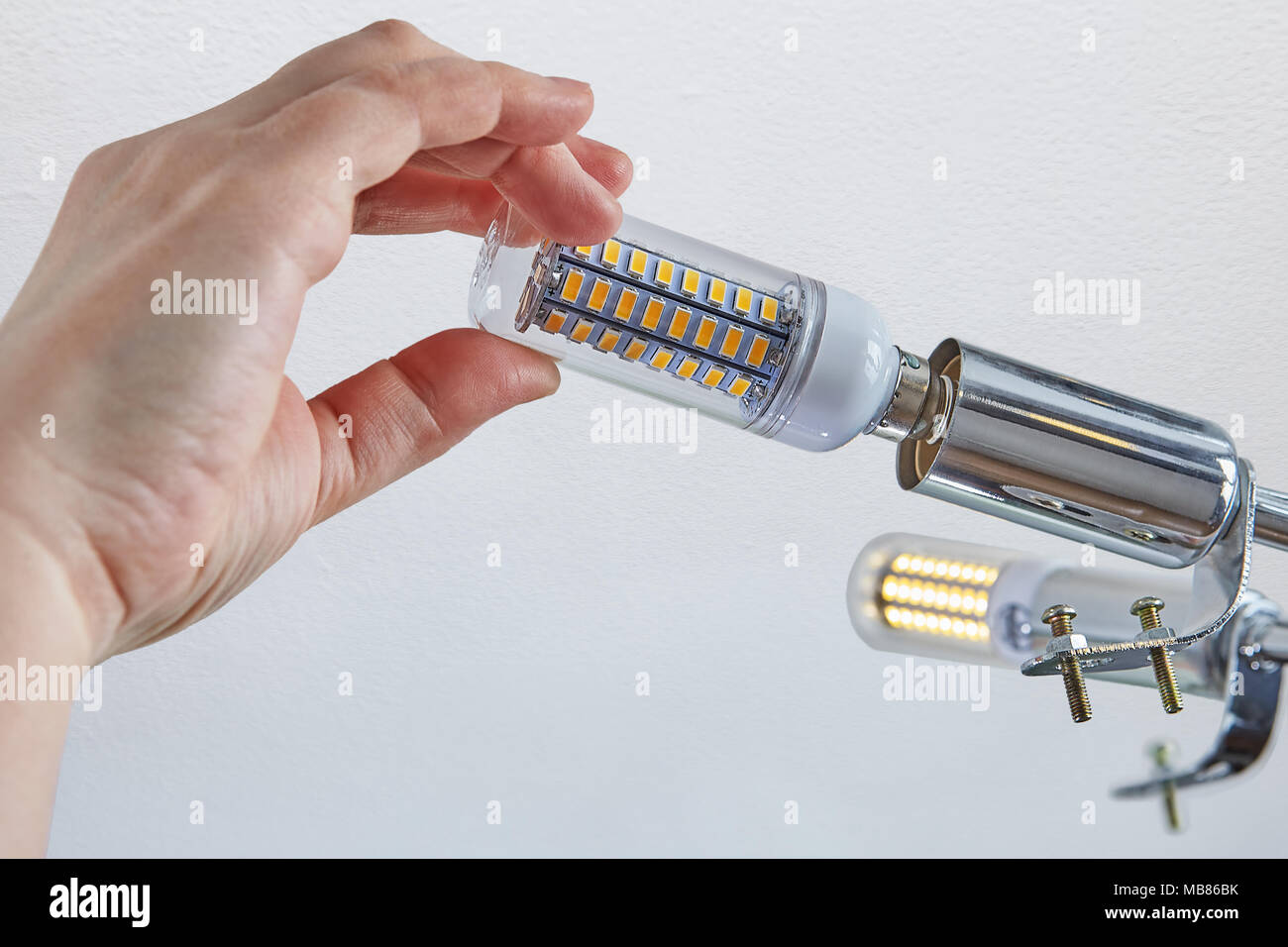 Replacing Lamps In Ceiling Light Close Up Of Female Hand Is