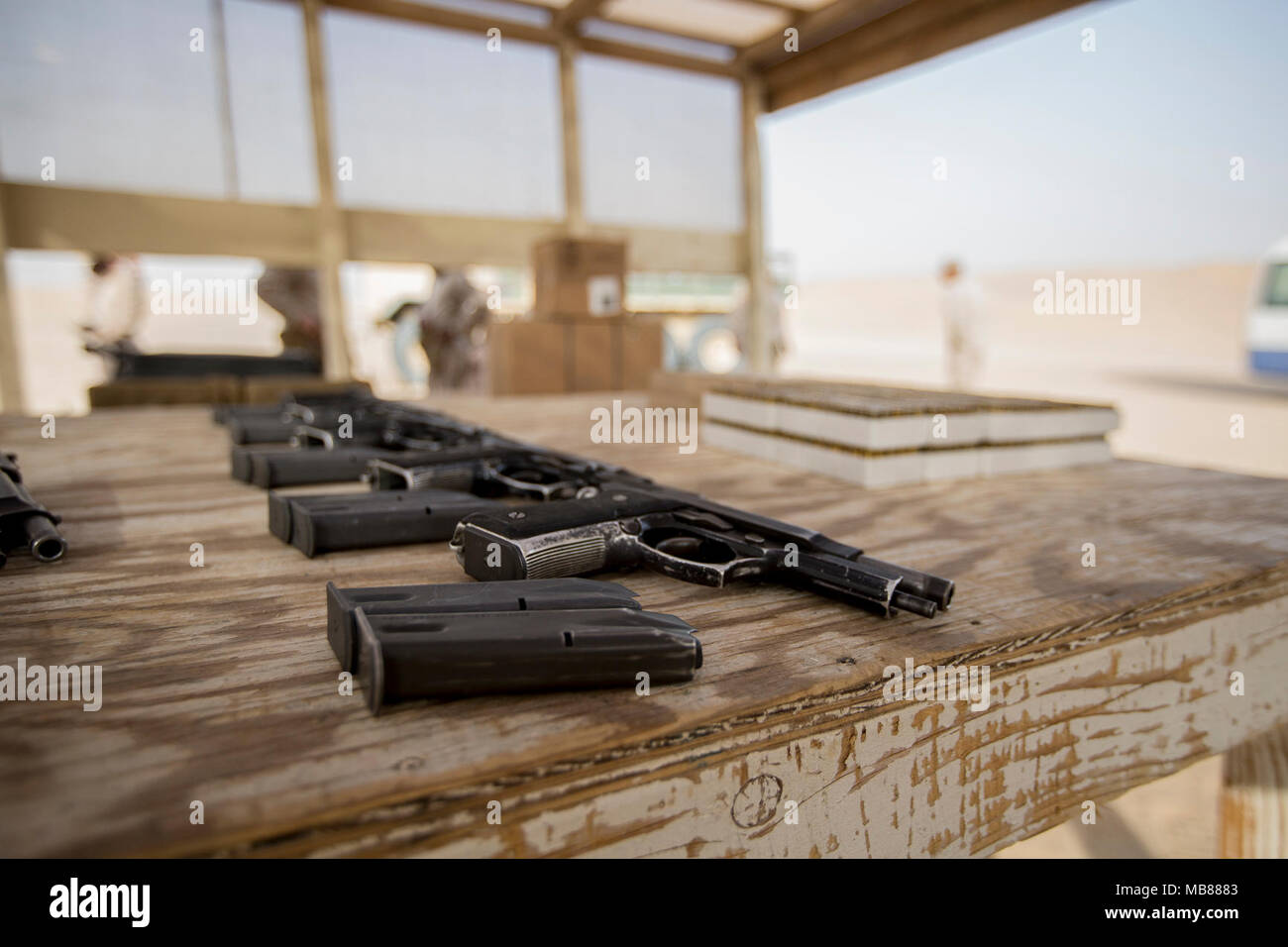 M9 service pistols and ammunition are laid out for U.S. Marines with Headquarters and Service Company, 2nd Battalion, 7th Marine Regiment, Special Purpose Marine Air-Ground Task Force – Crisis Response – Central Command to conduct a pistol range, Jan. 25, 2018. The purpose of the training was to increase lethality, solidify warrior ethos, and reinforce mastery of the basics. Stock Photo