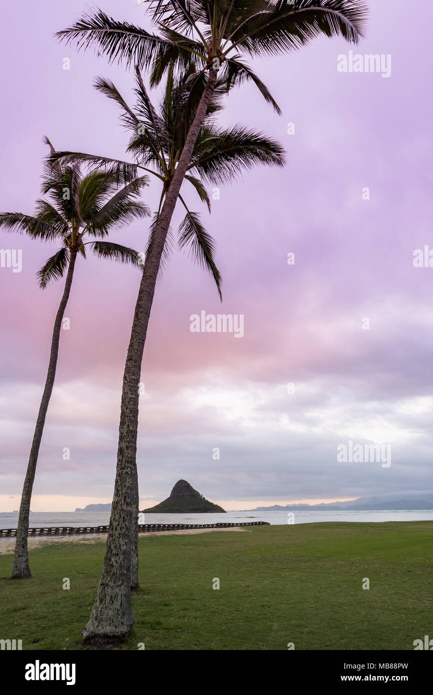 Purple Sunset over Chinaman’s Hat from Kualoa Beach Park on Oahu, Hawaii Stock Photo