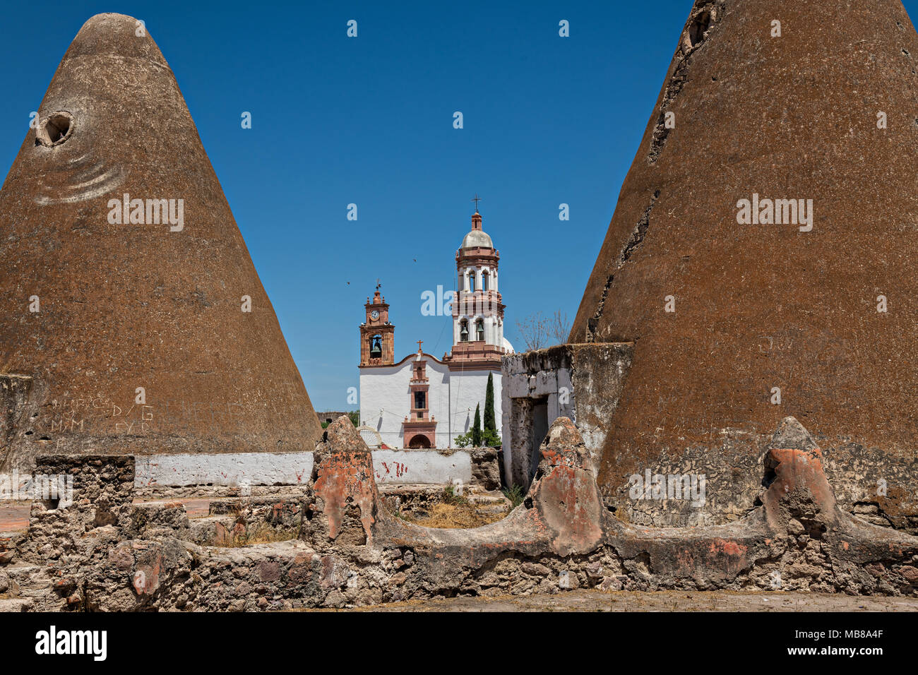 The Iglesia de San Diego De Alcalá church behind the pyramid shaped granaries at the Hacienda de