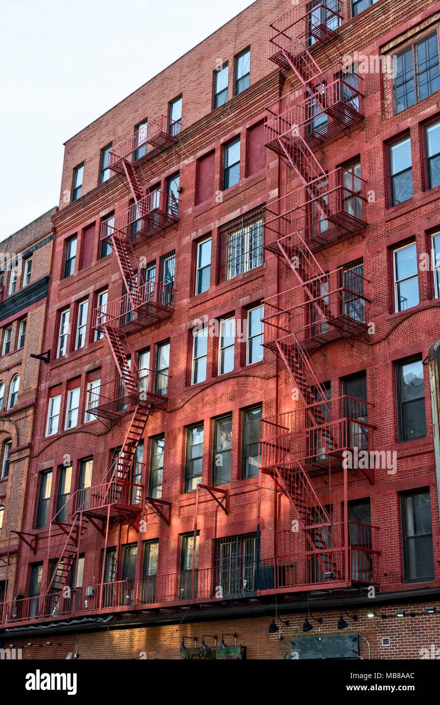 Grand Street, Manhattan, NYC, Little Italy Tenement Building.  Red Brick with Fire Escapes. Stock Photo