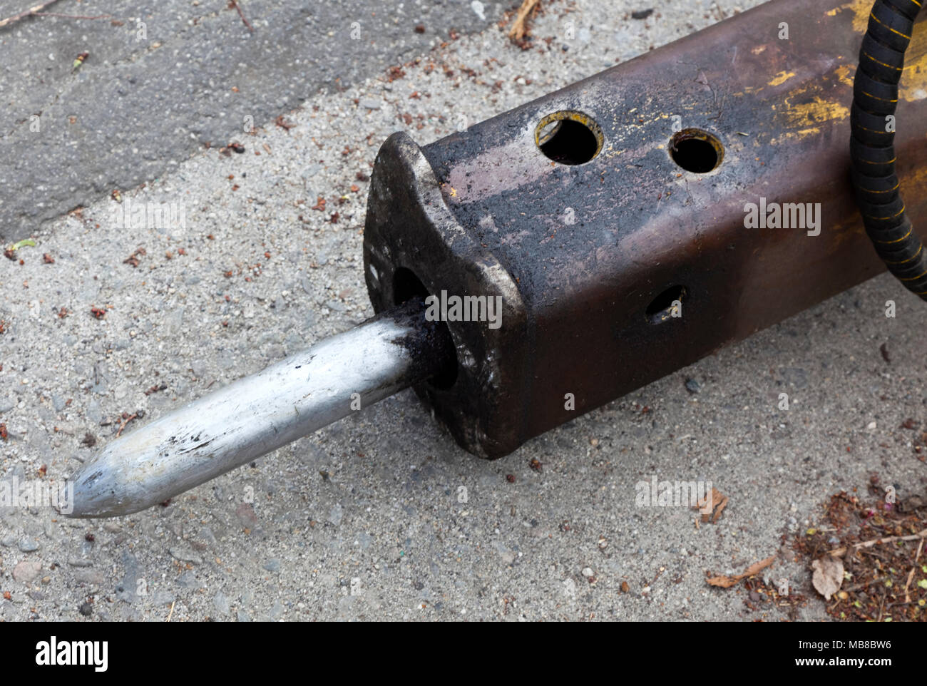 Detail of used, dirty, loud and efficient pneumatic hammer chisel. Stock Photo