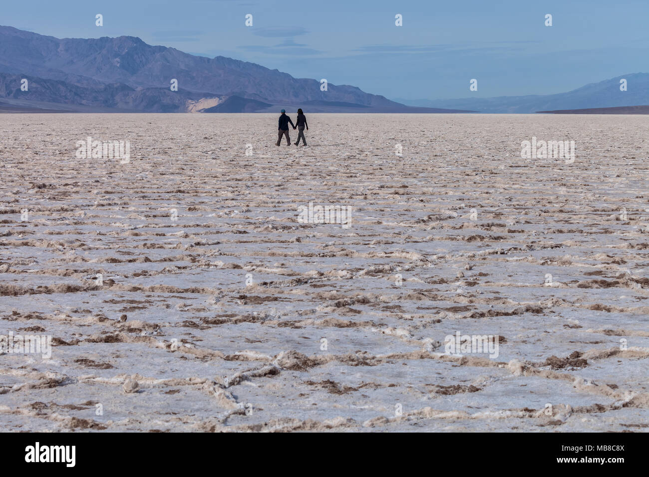 Couple were holding hand and hiking in Badwater Basin in Death Valley ...