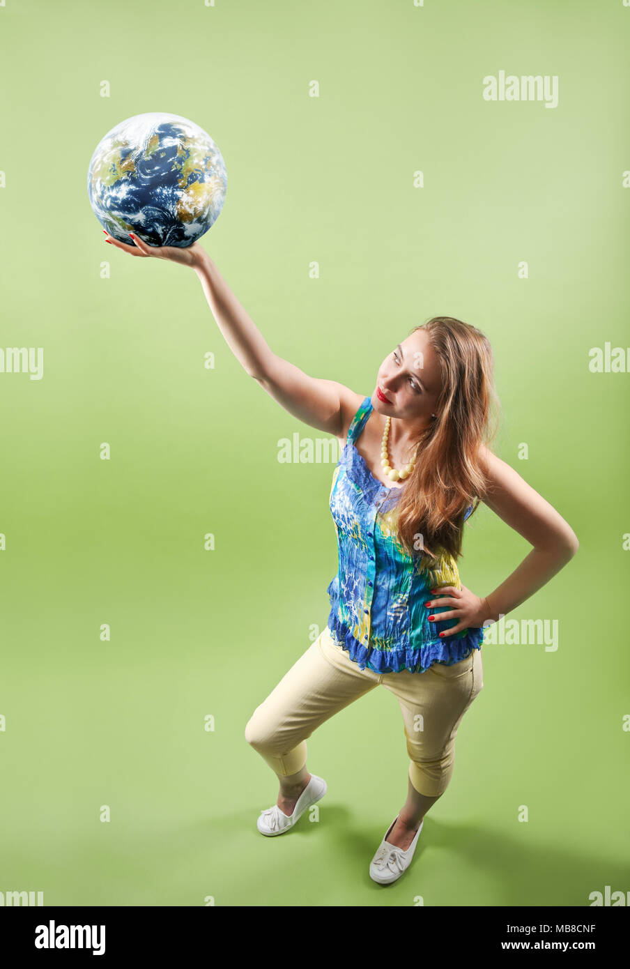 Woman holding the world in her hand Stock Photo