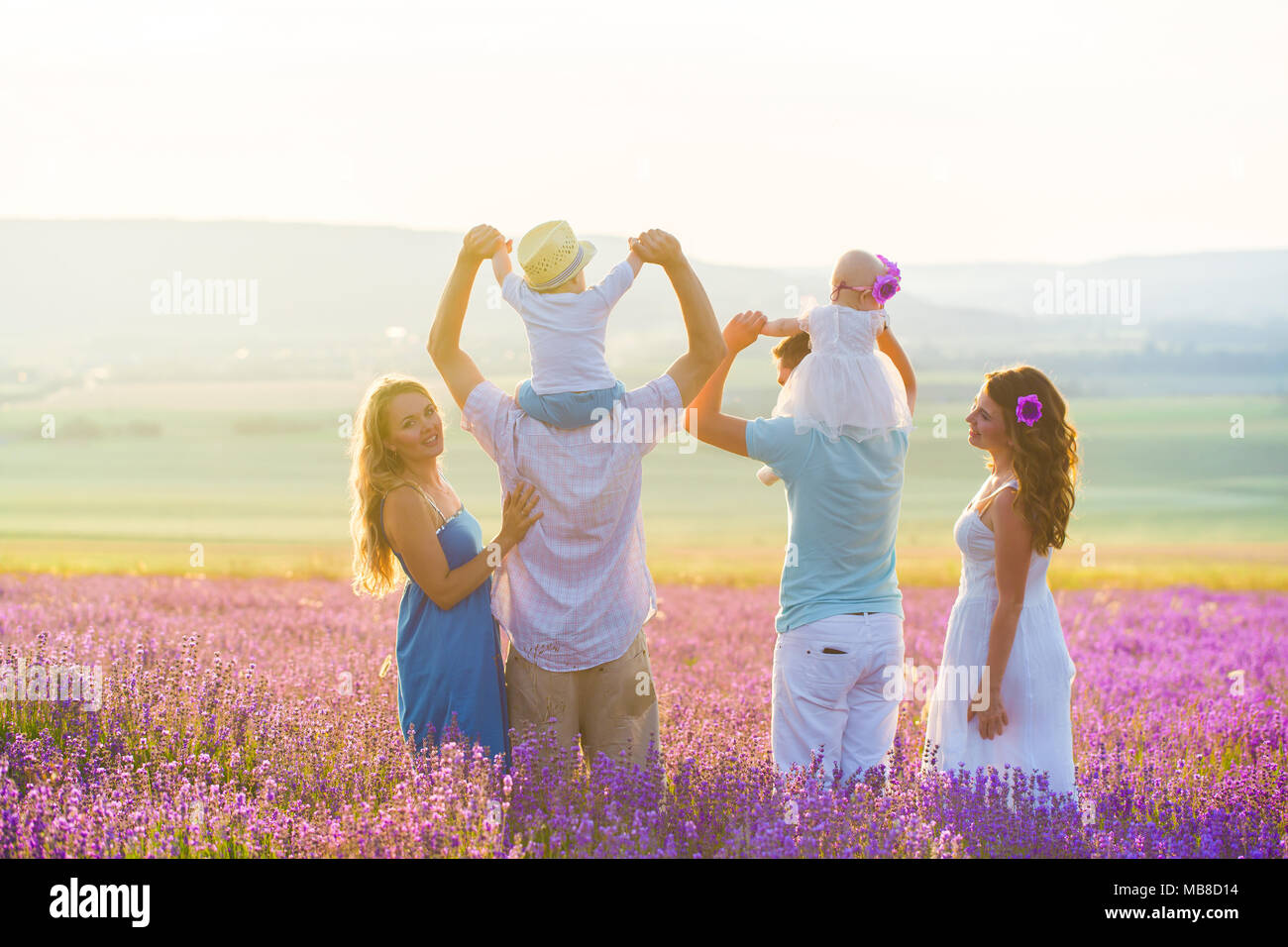 Two couples with their children have a rest in Provence. Beautiful young family with little boy and girl. Friends on vacation. Six people in the villa Stock Photo