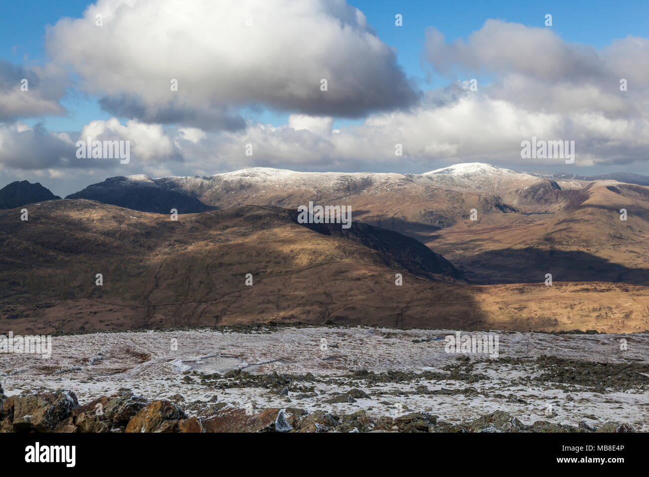 A view of the snow capped Carneddau mountain range in Snowdonia viewed from the summit of Moel Siabod Stock Photo