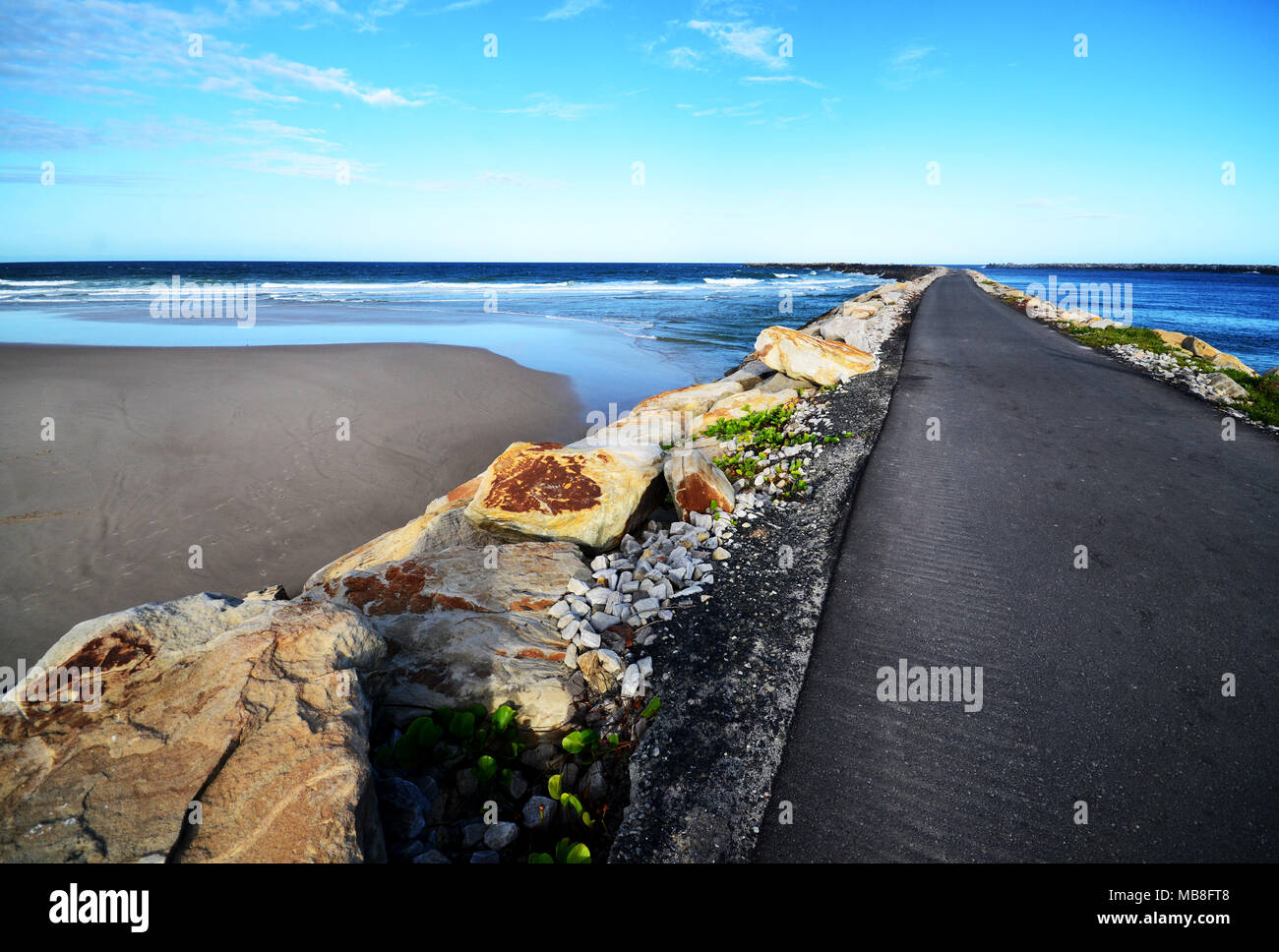 Road to nowhere extending out into the ocean Stock Photo