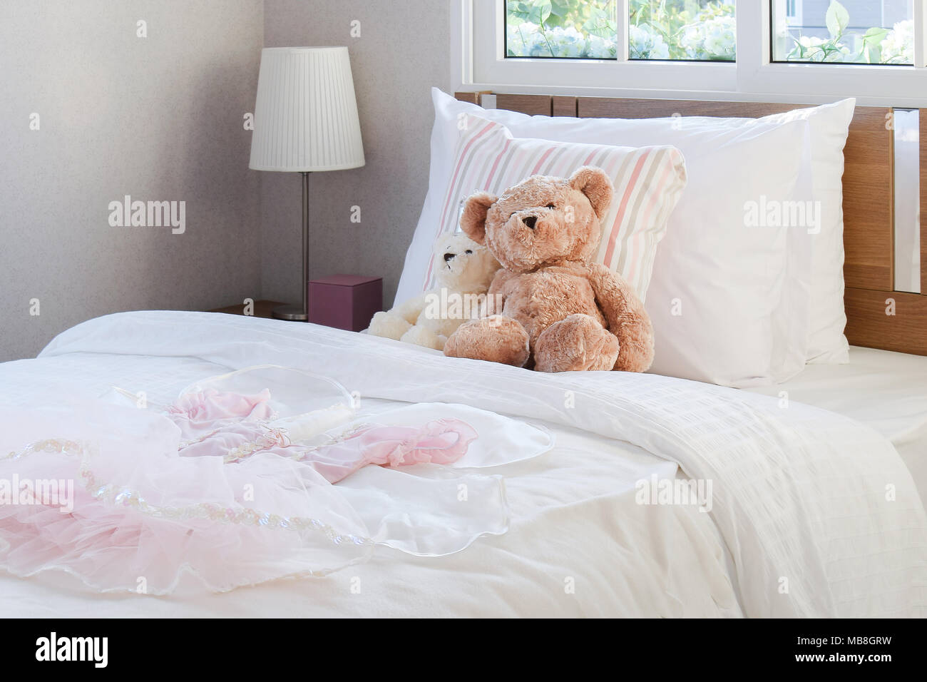 White Bedroom Decorative With Pillows And Dolls On Bed Stock Photo