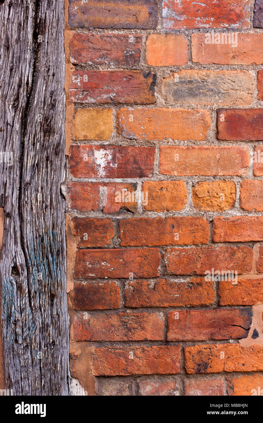 Old red brick wall with vertical wooden beam Stock Photo Alamy