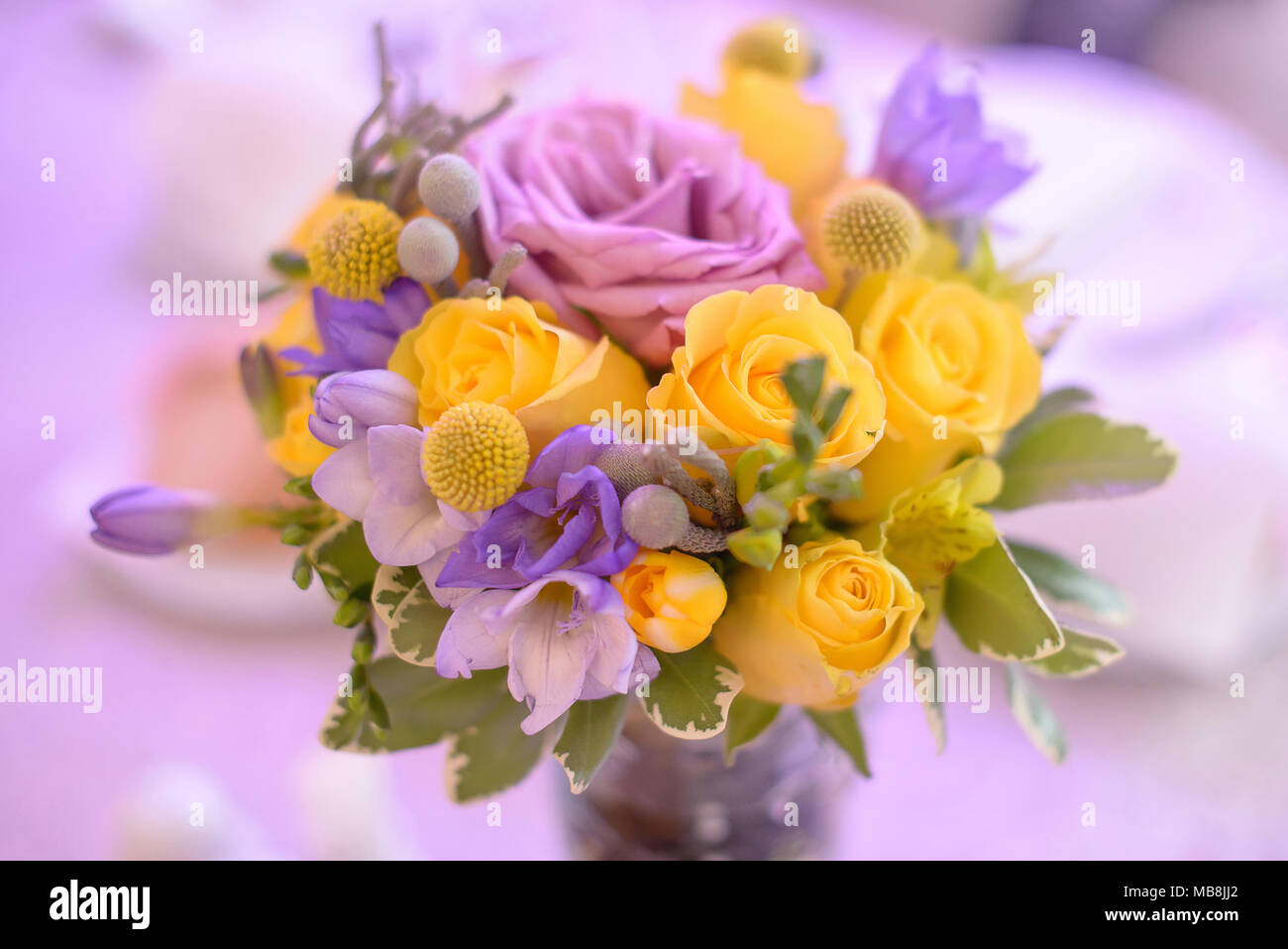 Fancy Colored Floral Arrangement With Bright Yellow And Purple