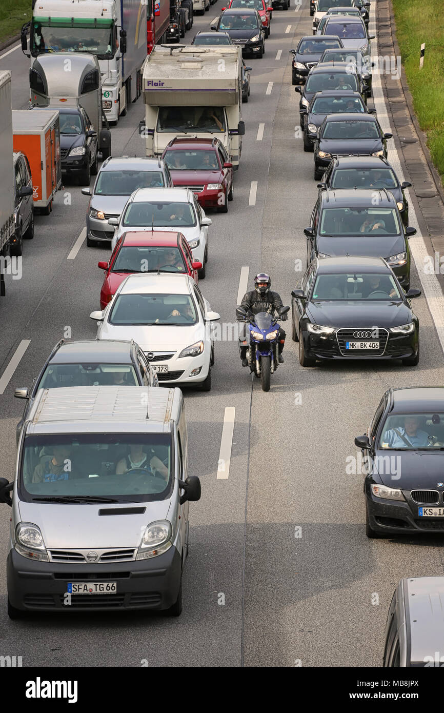 Biker in traffic jam Stock Photo