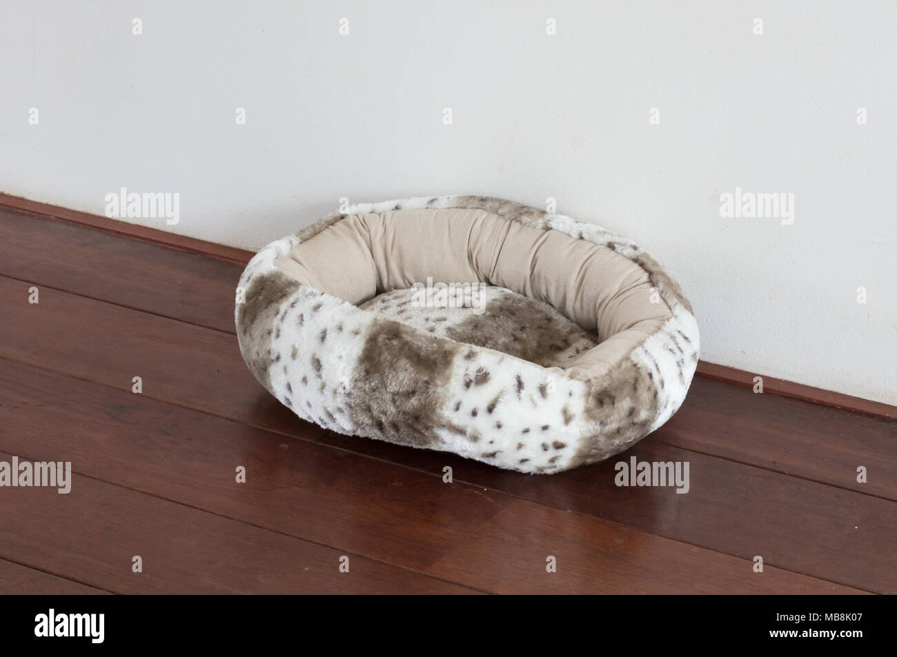 Fluffy basket for a cat, black hairs inside Stock Photo