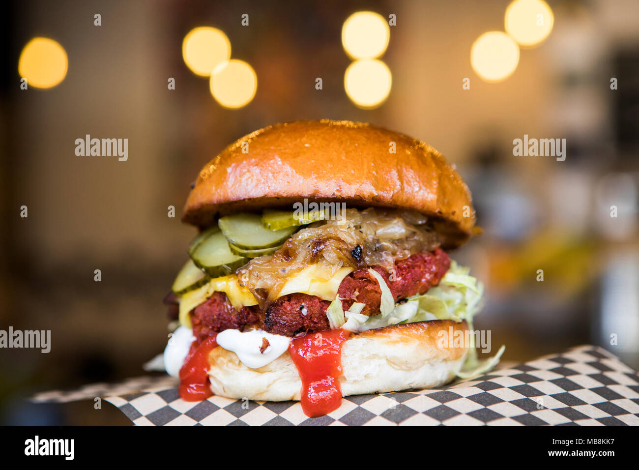 Vegan burger with vegan cheese, pickles and ketchup. Stock Photo