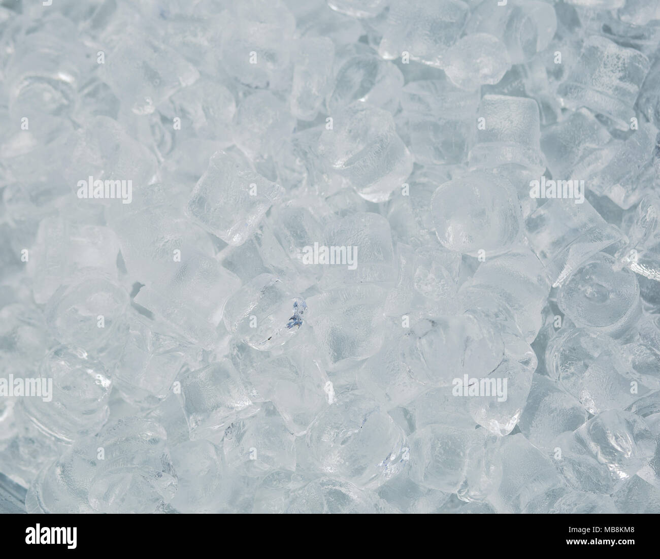 Top view of many transparent cubes of ice ready to use in drinks and cocktails. Icy background. Stock Photo