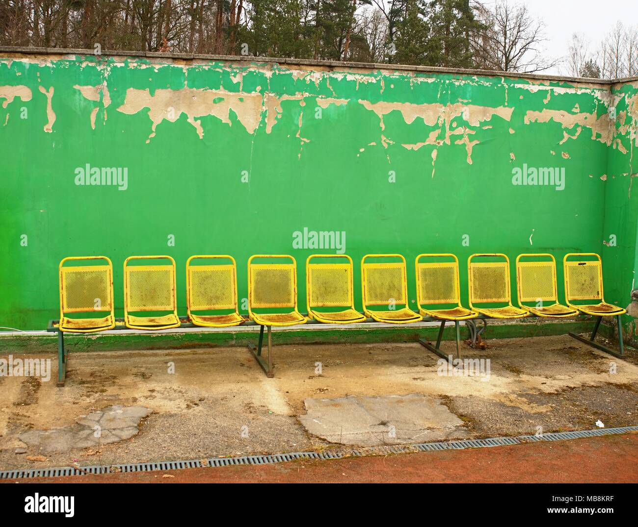 Vintage steel seats on outdoor stadium players bench chairs with worn