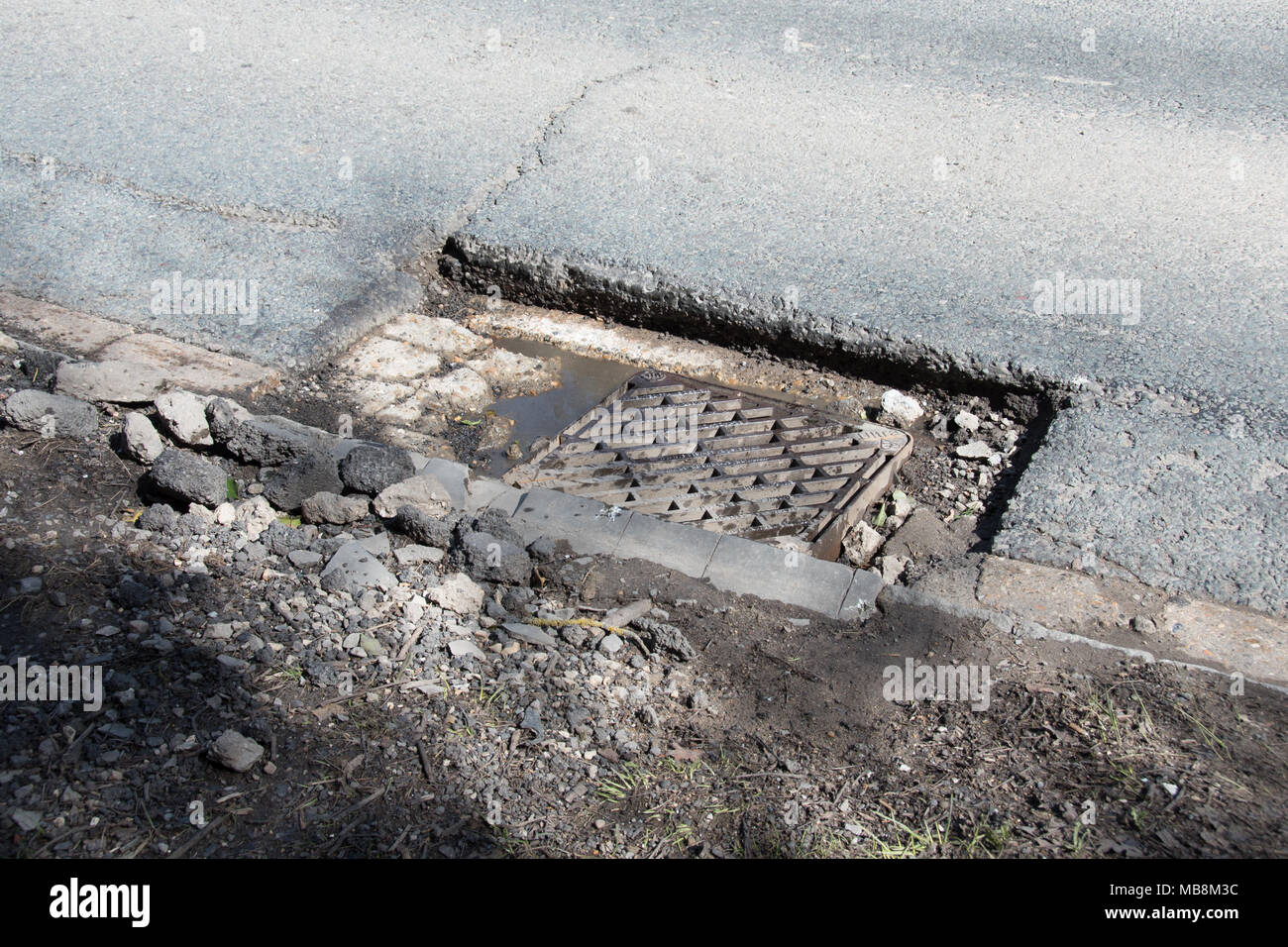 pothole in road Stock Photo