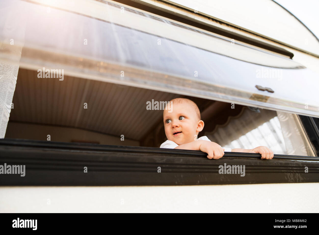 Baby boy in a camper van Stock Photo Alamy
