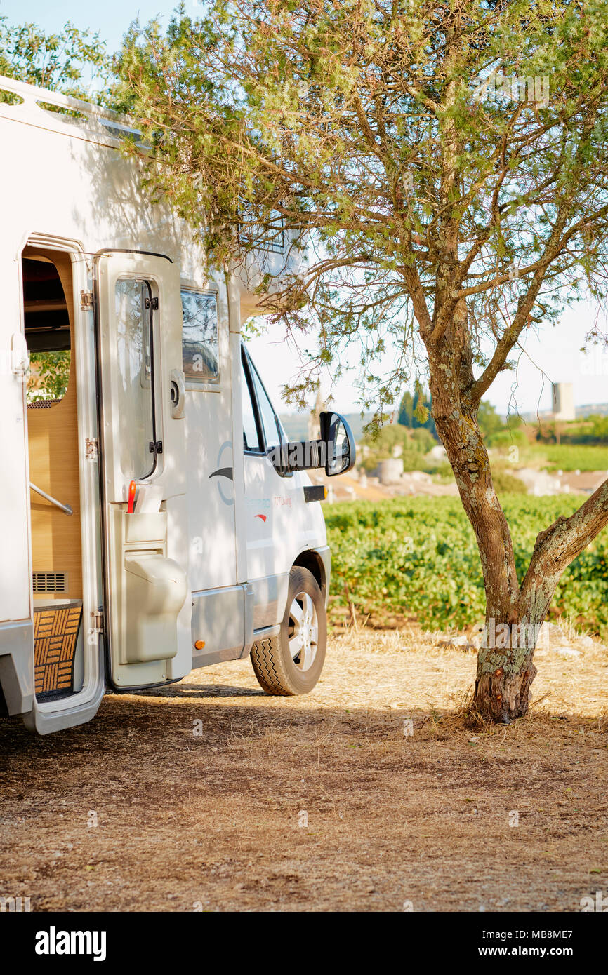 A parked motorhome in a typical village aire in France. Stock Photo