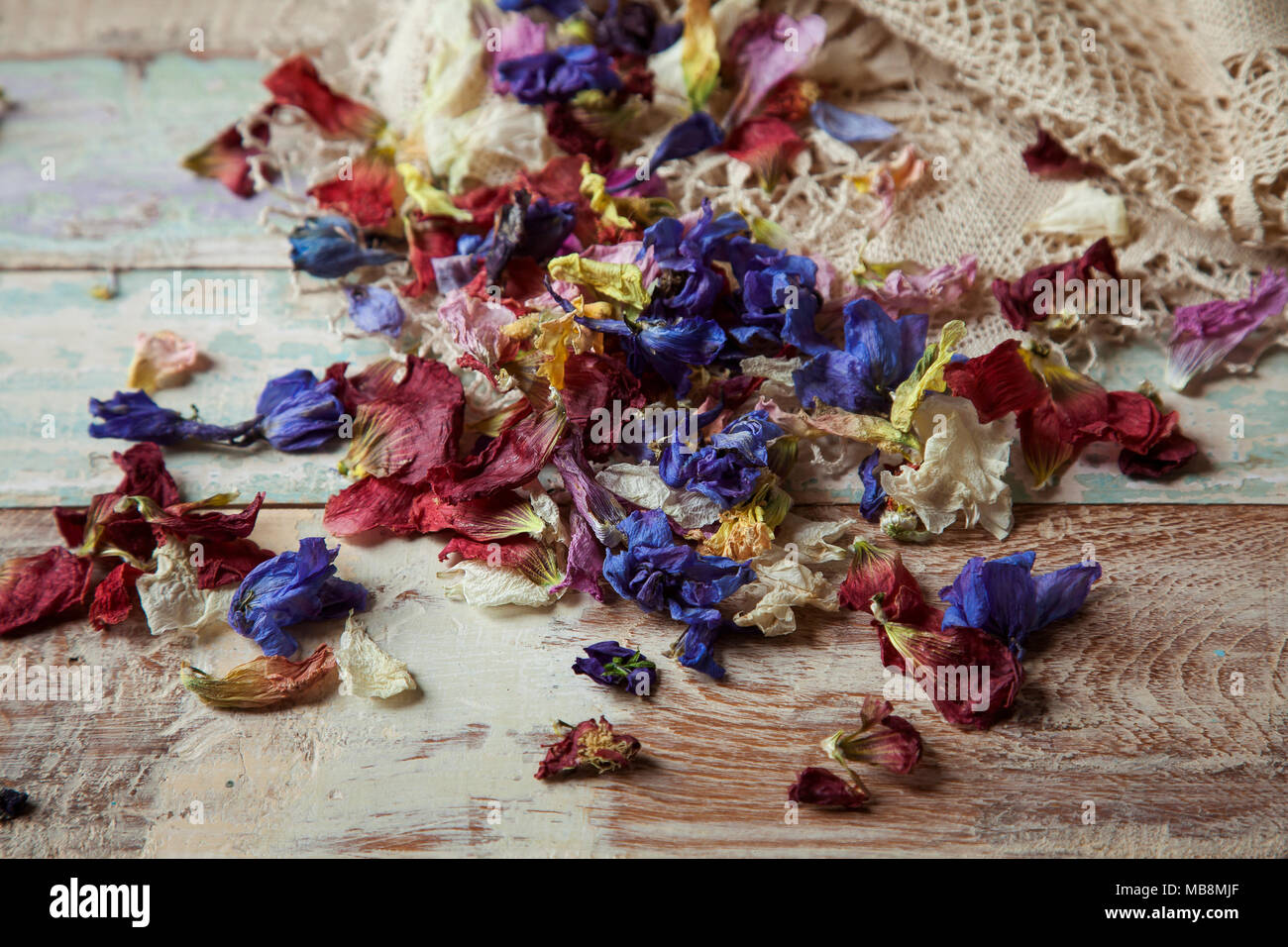 Dried flower petals for wedding confetti on wooden background with