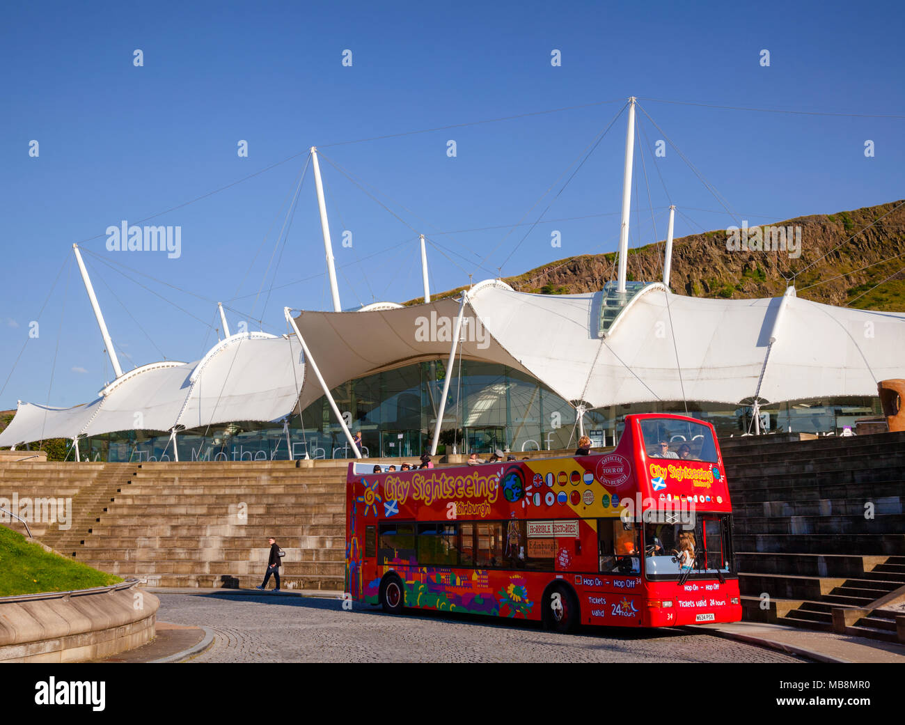 EDINBURGH, UK - AUG 8, 2012: Touristic red double-decker hop-on hop-off City Sightseeing tour bus at the Dynamic Earth, a popular science attraction a Stock Photo