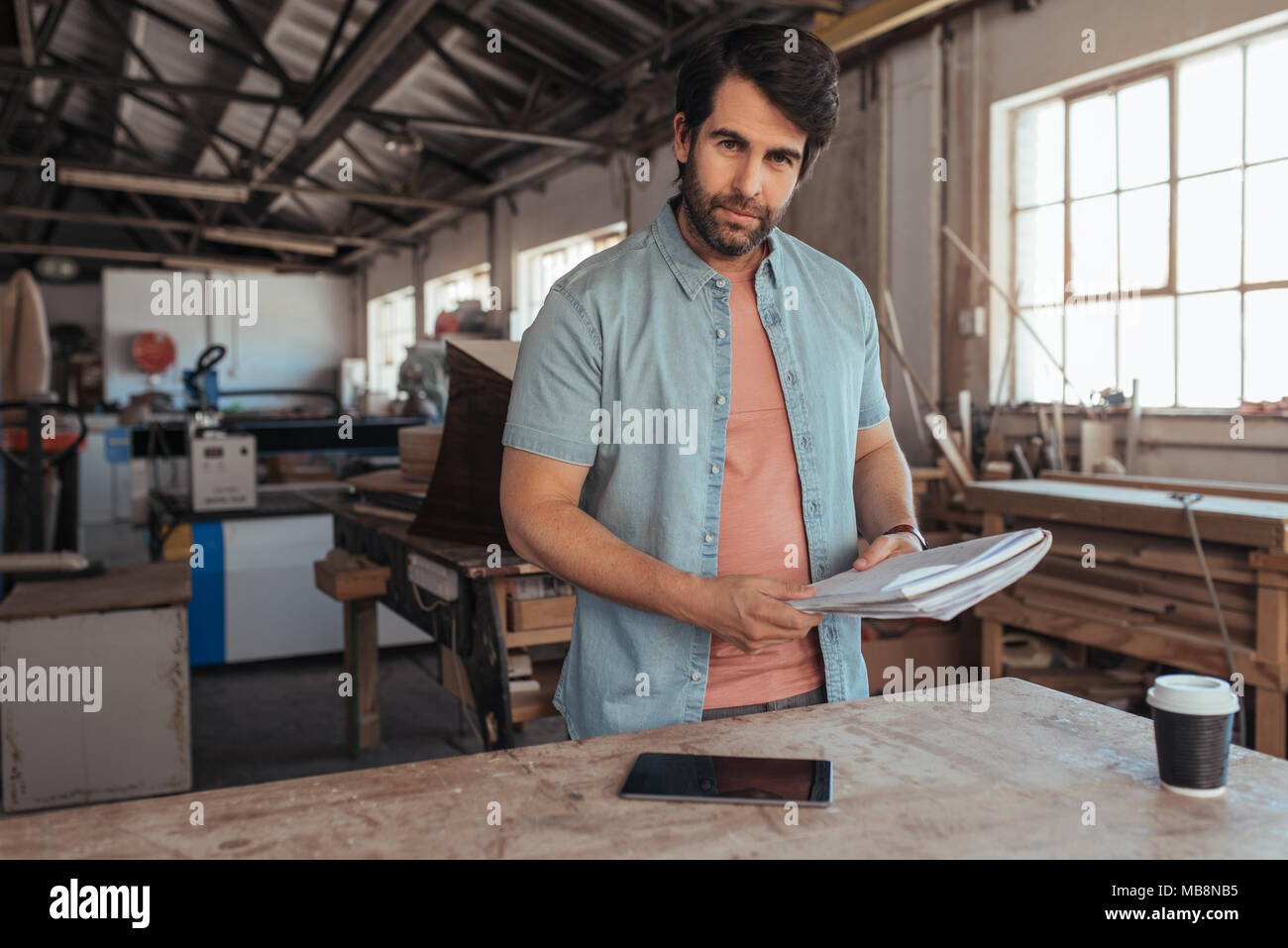 Skilled carpenter coming up with new designs in his workshop Stock Photo