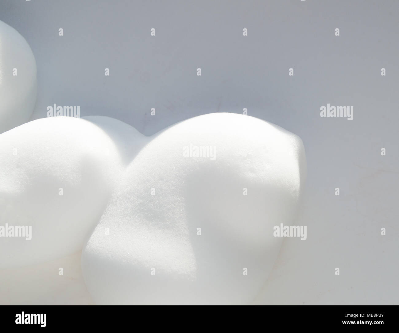 Drops of shaving foam, mousse or hair styling foam on white background