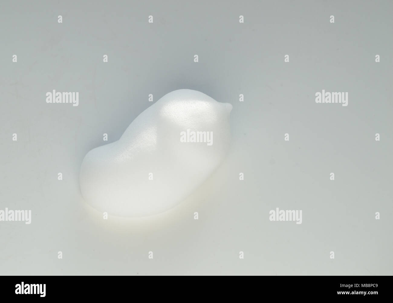 Drops of shaving foam, mousse or hair styling foam on white background