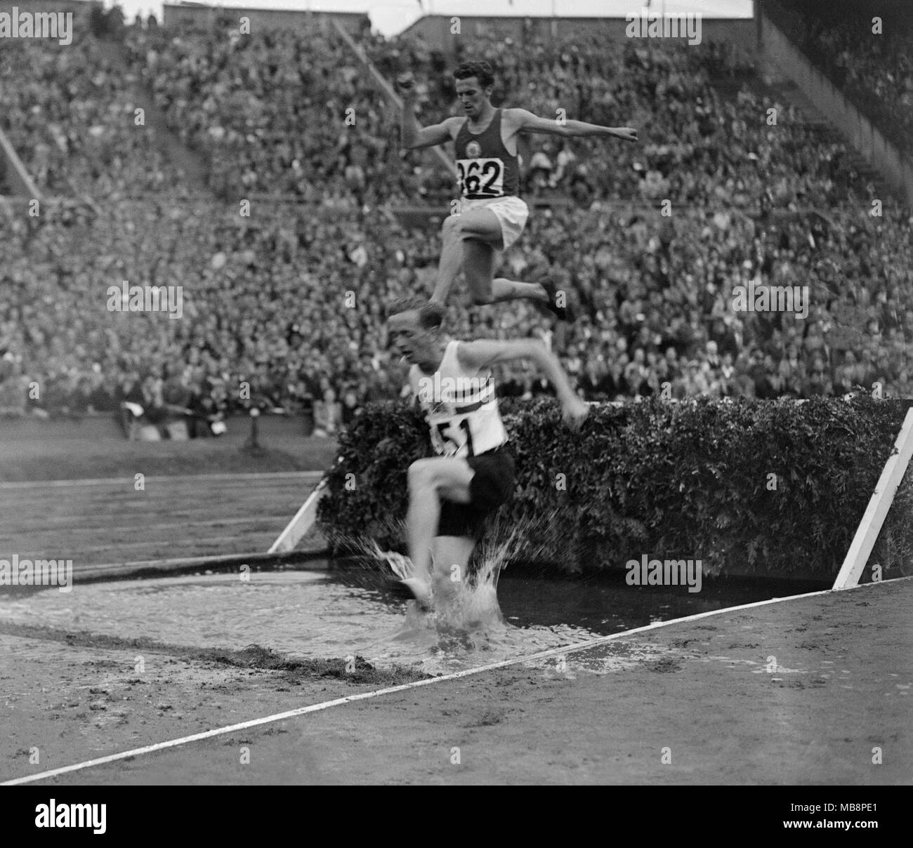 1948 Olympic Games.London. British athlete Peter 'TPE' Curry competing in the 3000 metre steeplechase. Curry retired from athletics at the end of the year and became one of the country's leading barristers.Curry represented John Lennon, George Harrison and Ringo Starr in a court case against Paul McCartney over the Apple record company in 1975 and at the start of the eighties he represented investors in the Banco Ambrosiano and attempted to retrieve money laundered from the bank by the Sicilian Mafia. Stock Photo