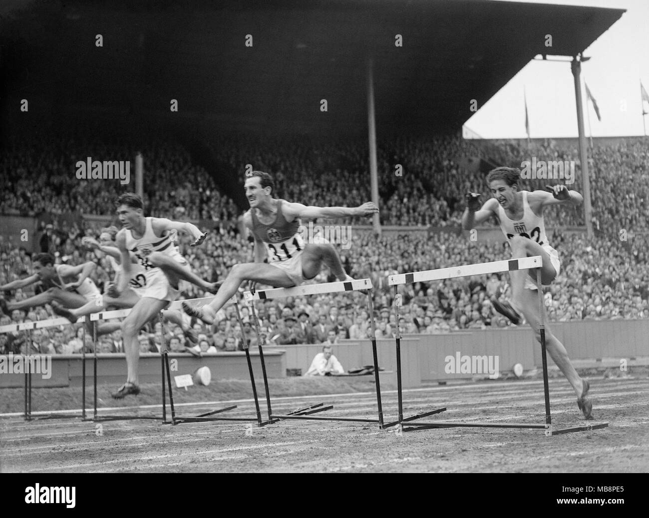 Olympic Games. 1948. London. Heat of the 110 metre hurdles, including British Athlete Joe Birrell, third athlete from the right. Stock Photo