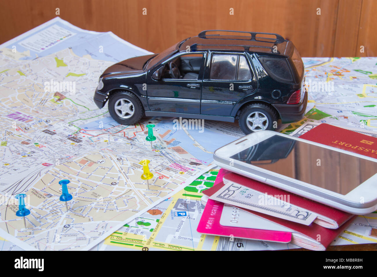 Plan your journey by car, a passport, money, cards, mobile phone Stock Photo