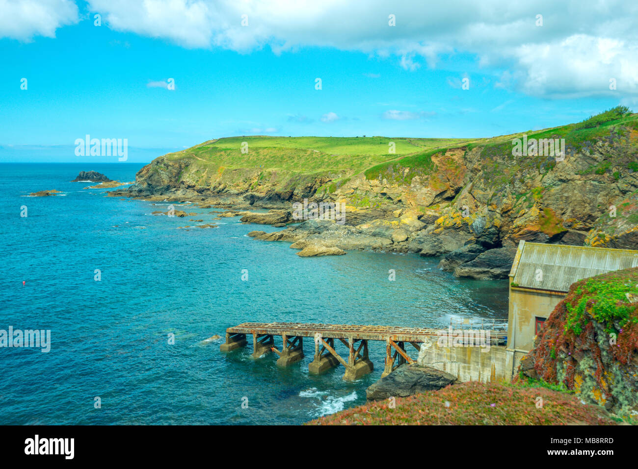 A boat house and slipway in a small bay at Lizard Point in Cornwall, the most southerly part of the British Isles Stock Photo