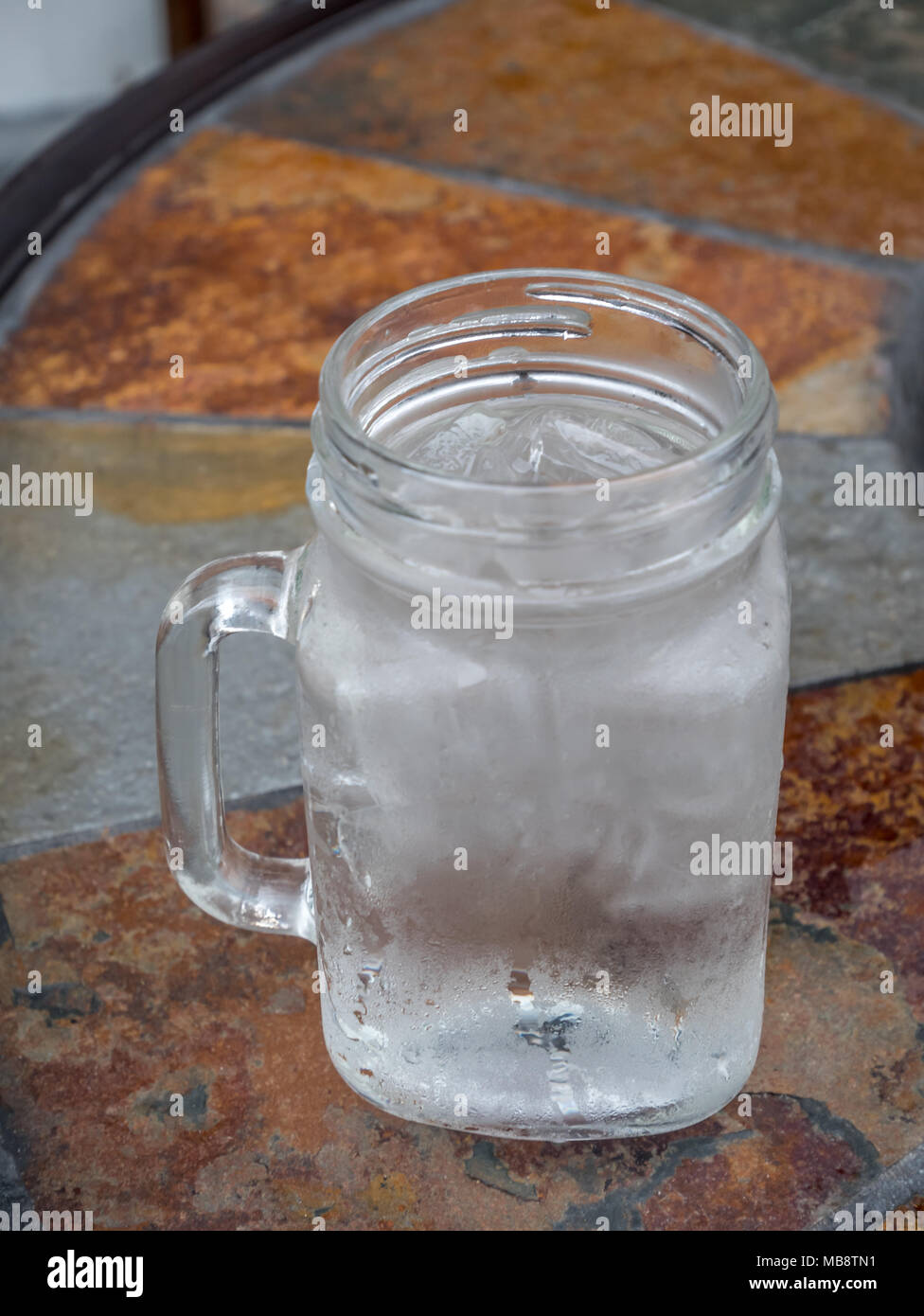 Glass Jug Full of Water and Ice Cubes on Ceramic Table Stock Photo - Alamy
