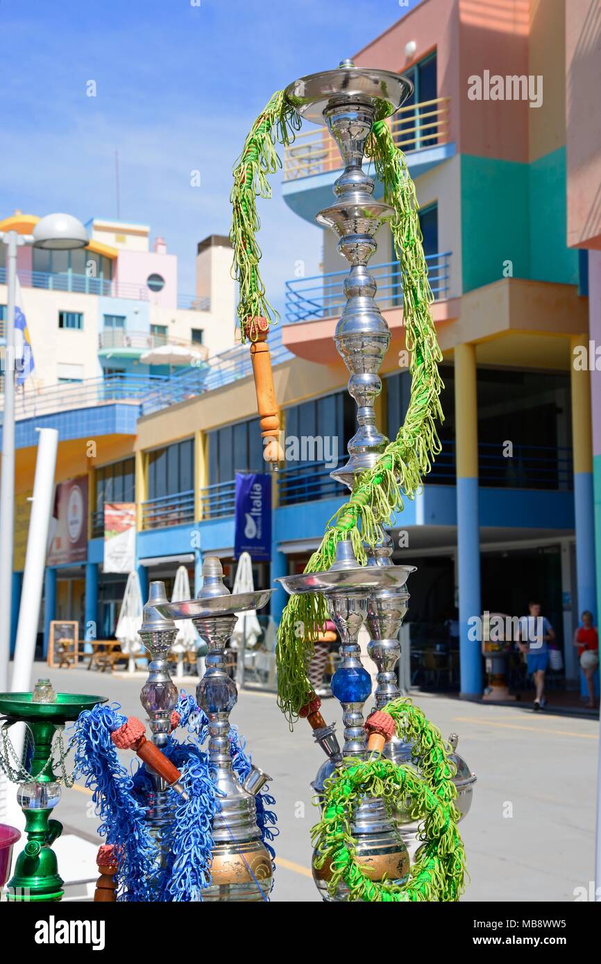 Hookah pipes at a waterfront restaurant in the marina with buildings to