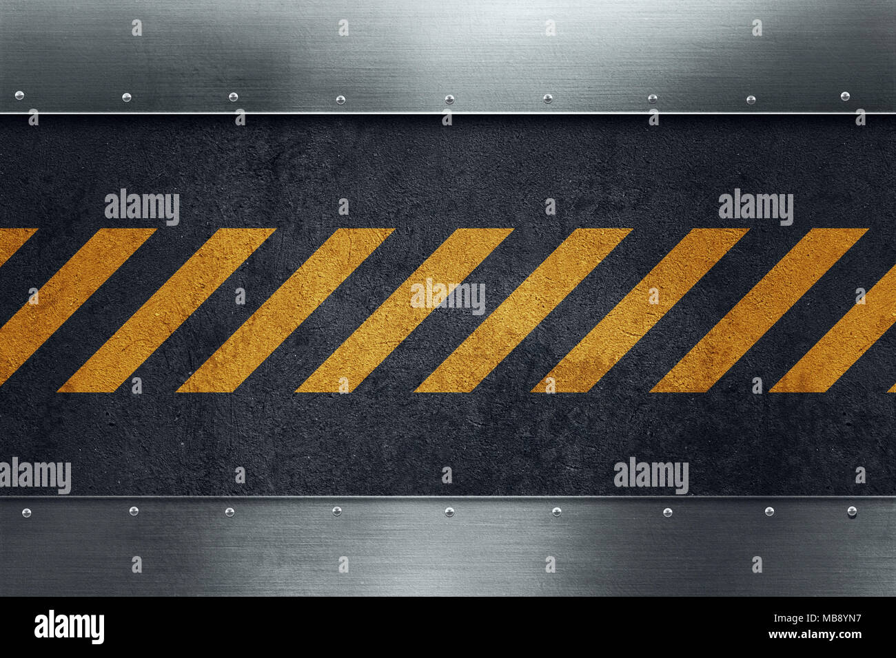 Black dirty grungy asphalt surface with yellow warning stripes. Polished metal plates with rivets. Place for your text. Stock Photo