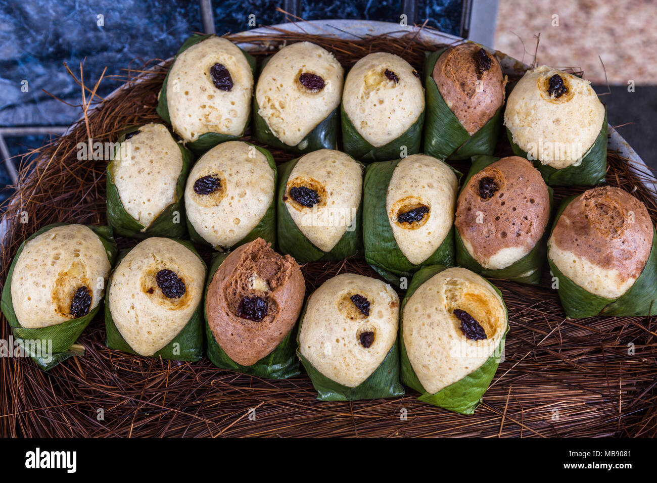 Quimbolitos, cornmeal cakes and wheat; wrapped in a achira leaf  (Canna indica) steamed Stock Photo