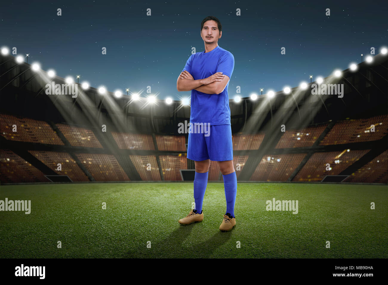 Handsome asian soccer player with blue jersey standing on the stadium field  Stock Photo - Alamy