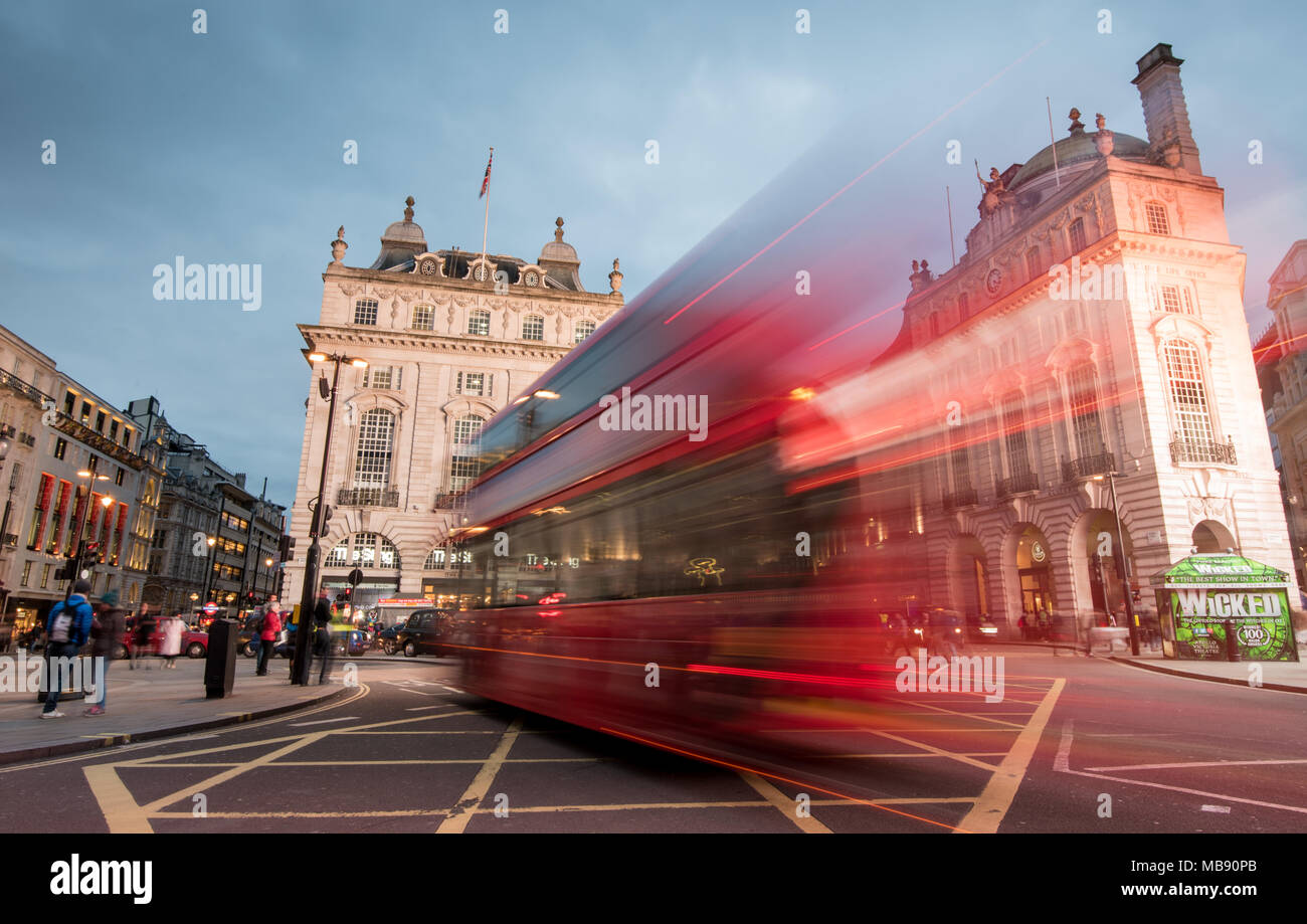 London, England - March 19, 2018: Night scene from the famous London Piccadilly circus square  at the center of London with cars and buses leaving col Stock Photo
