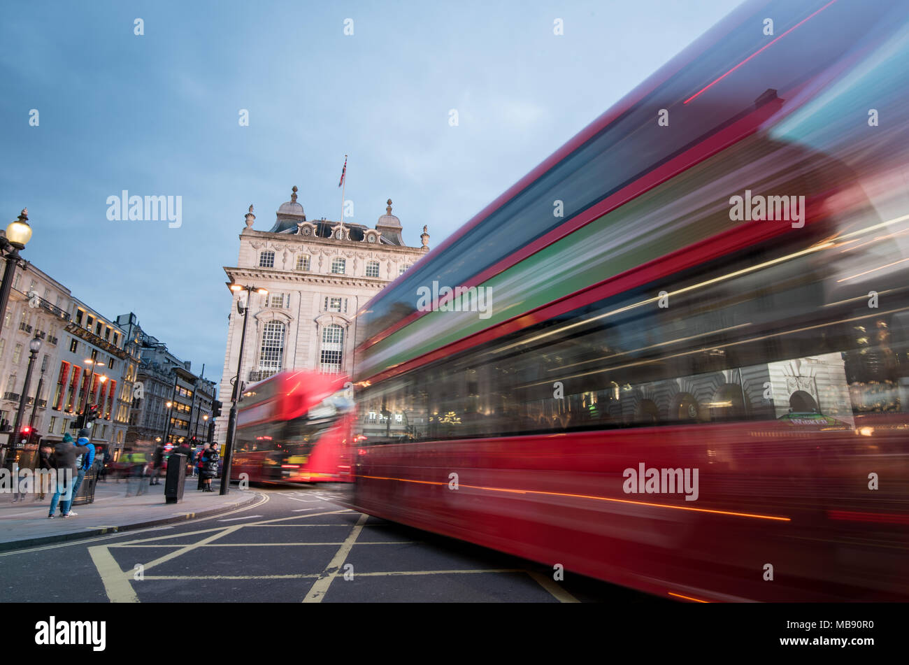 London, England - March 19, 2018: Night scene from the famous London Piccadilly circus square  at the center of London with cars and buses leaving col Stock Photo