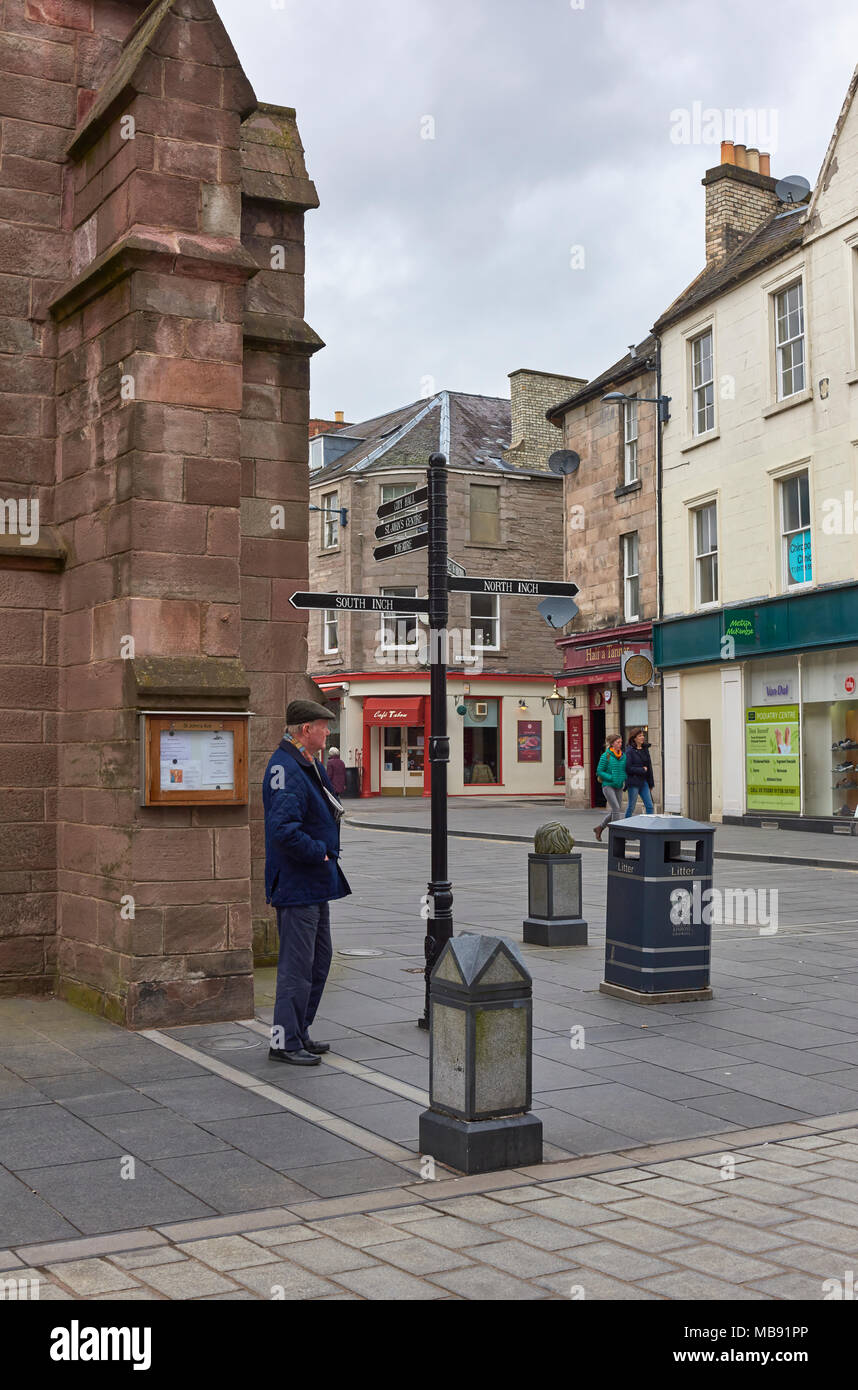 A man waiting at the Street Corner next to St John's Church one Saturday afternoon in Spring in Perth, Perthshire, Scotland. Stock Photo
