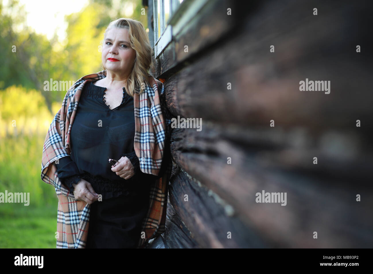 An elderly woman on the porch of a house Stock Photo - Alamy
