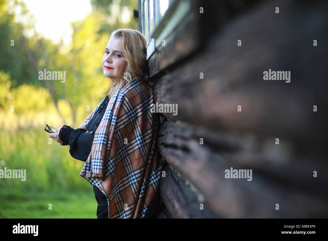 An elderly woman on the porch of a house Stock Photo - Alamy
