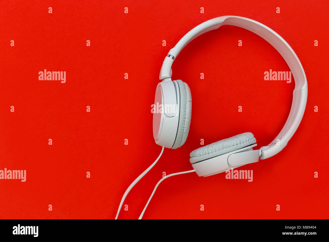 White music headphones isolated on bright red background Stock Photo Alamy