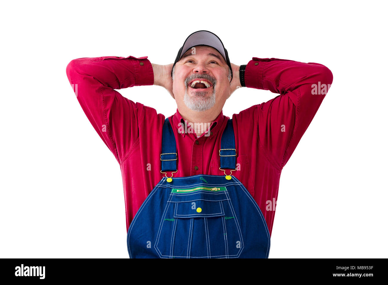 Cheerful worker wearing dungarees standing against white background Stock Photo