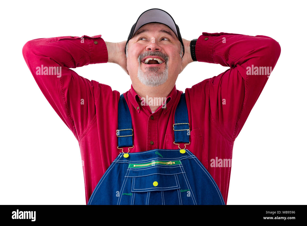 Cheerful farm worker wearing dungarees against white background Stock Photo